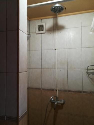 a shower in a bathroom with a shower head at Oāze Smiltenē in Smiltene