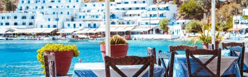 a table with chairs and potted plants on top of the water at Traditional Villa Askyfou in Karés