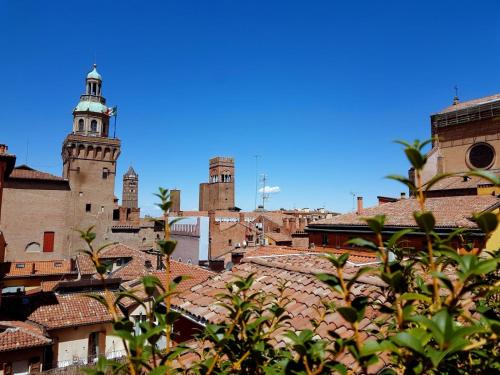 a view of a city with buildings and a clock tower at Hotel Roma in Bologna