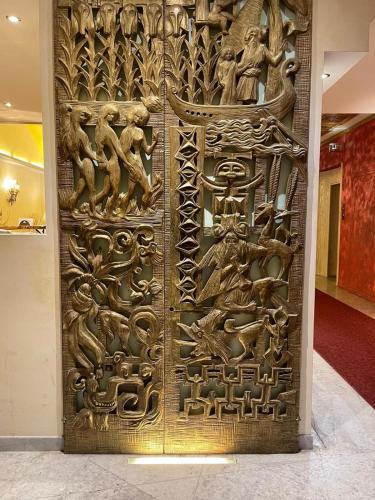 a golden door in a building with people on it at Hotel Roma in Bologna