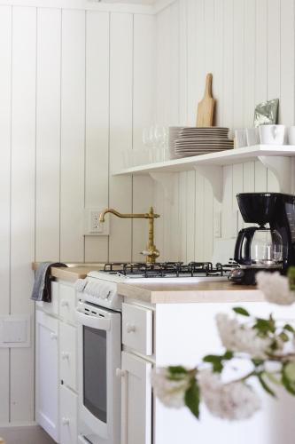a kitchen with white cabinets and a stove top oven at Anchor Inn in Traverse City