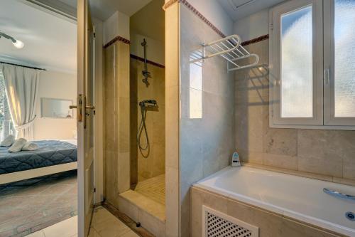 a bathroom with a bath tub and a shower at LA PERLA DE LA BAHIA PRIMERA LINEA in Casares