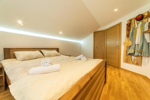 a bedroom with a large bed with two towels on it at Seosko domaćinstvo Kastratović in Berane