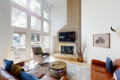 a living room with a couch and a fireplace at Springs of Arrowhead in Edwards