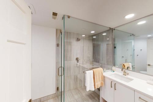 a bathroom with a glass shower and a sink at Springs of Arrowhead in Edwards