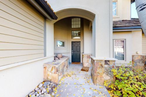 a front door of a house with leaves on the ground at Springs of Arrowhead in Edwards