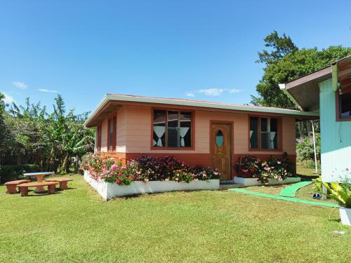 a house with a bench and flowers in the yard at Campo Azul - Monteverde in Monteverde Costa Rica