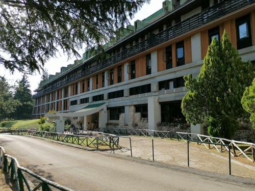 a large building with a road in front of it at Natura, Sport, Relax in Pescasseroli Residence ERICA in Pescasseroli