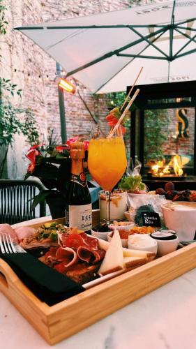 a tray of food on a table with a drink at Hotel El Coloquio in Valladolid