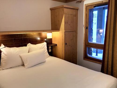 Säng eller sängar i ett rum på Superbe Appartement 6 personnes Ski-in Ski-out Arc 1950