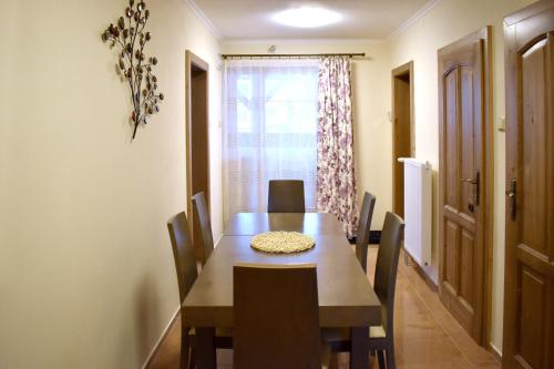 a dining room with a wooden table and chairs at Chalupa pod Tatrami in Liptovská Teplička