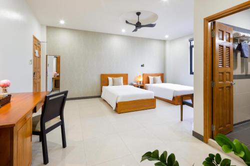 Postel nebo postele na pokoji v ubytování LARA HOTEL LONG XUYÊN