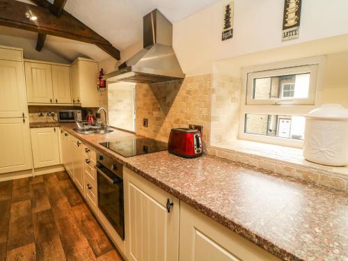 a kitchen with white cabinets and a counter top at Anvil Barn in Bainbridge