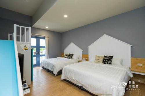 Ein Bett oder Betten in einem Zimmer der Unterkunft Blue White