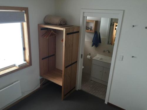 a bathroom with a sink and a toilet and a mirror at Ripparoo Lodge in Falls Creek