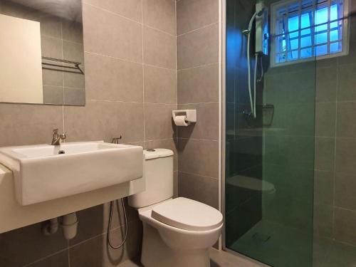 a bathroom with a toilet and a sink and a shower at Gerard's Place Nature Haven Apartment in Tanah Rata