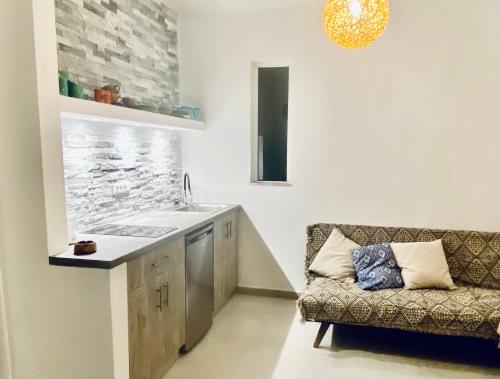 a living room with a couch and a sink at Marmaraki Village House & Apartments in Kardamaina