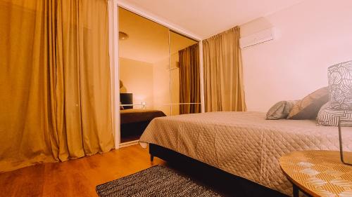 a bedroom with a bed and a room with a mirror at Newly Renovated Super-Chic Apartment in Nicosia