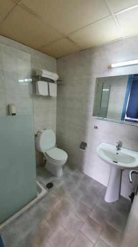 a bathroom with a toilet and a sink at Athens Lydia Hotel in Athens