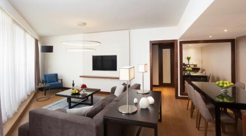 a living room with a couch and a table at Royal Beach Eilat by Isrotel Exclusive in Eilat