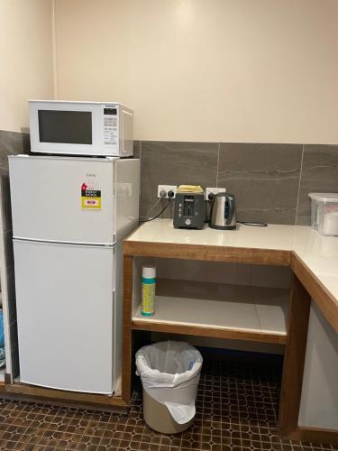 a kitchen with a microwave on top of a refrigerator at Jerilderie Motor Inn in Jerilderie