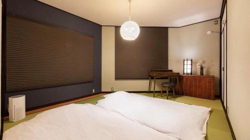 a bedroom with a large bed and a desk at Shiori in Kyoto
