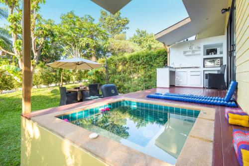 a small swimming pool in the backyard of a house at Moon Cottage in Choeng Mon Beach