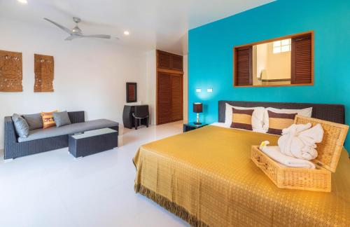 a large bedroom with a bed and a couch at Moon Cottage in Choeng Mon Beach