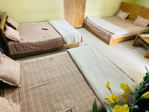 a room with two beds and a table at Hotel Garden City in Barpāra
