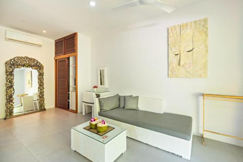 a living room with a couch and a table at Moon Cottage in Choeng Mon Beach