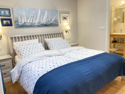 a bedroom with a bed with a blue blanket at Rohrmann apartments in Ljubljana