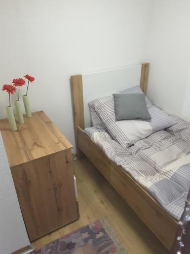 a bedroom with a bed and a table with vases at Ferienhaus Käthe in Wutha-Farnroda