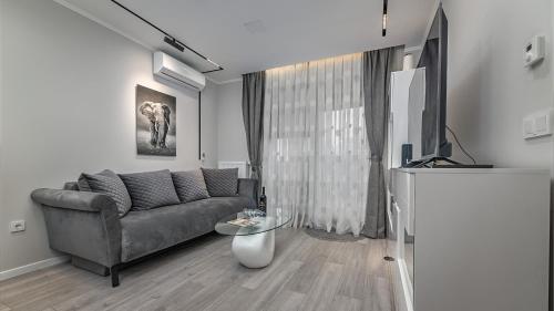 a living room with a couch and a tv at Apartman Nostra in Zagreb