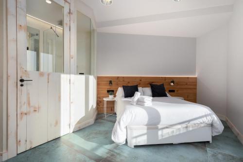 a bedroom with a white bed and a mirror at Your home at Valencia, Marina Real in Valencia
