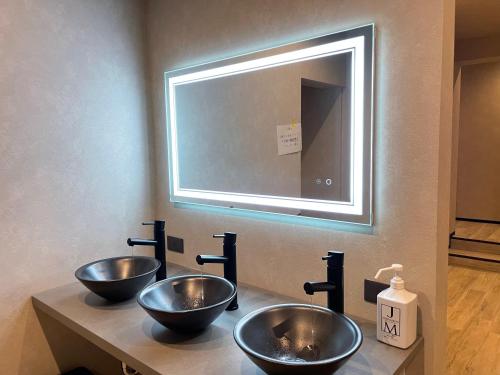 three bowls sitting on a counter with a mirror at TOCORO. Mt.Fuji Station HOSTEL Kawaguchiko in Fujikawaguchiko