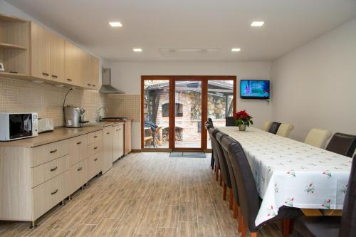a kitchen with a table and a counter top at Casa dintre Brazi Hunedoara in Hunedoara