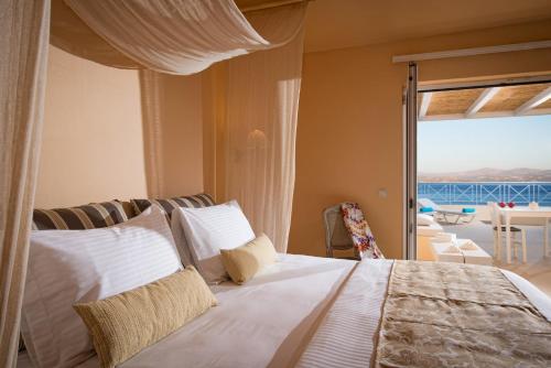 Astoria Hotel في أغيا غاليني: غرفة نوم مع سرير وإطلالة على المحيط