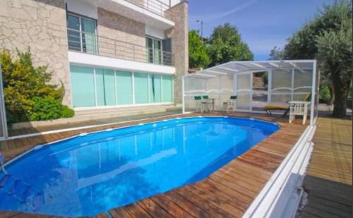 a swimming pool in front of a house at Casa Ze da Cotta in Vila Verde