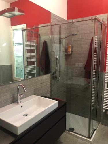 a bathroom with a sink and a glass shower at Il Castello - Appartamento in zona residenziale in Modena