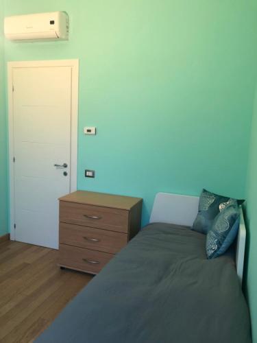 a bedroom with a bed and a dresser and a door at Il Castello - Appartamento in zona residenziale in Modena