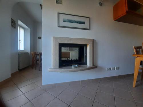 a living room with a fireplace in the wall at PIGGIOLO in Rocca Malatina