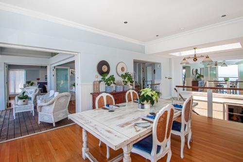 a dining room with a table and chairs at A Boat House in Simonʼs Town