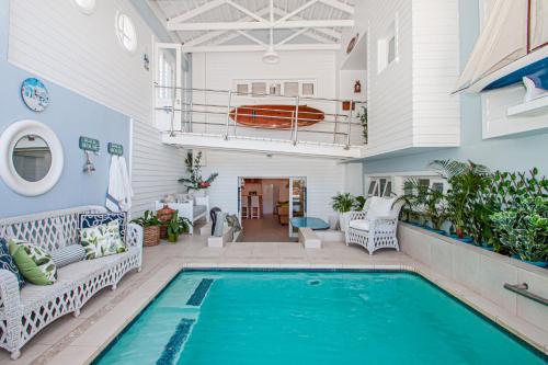 a house with a swimming pool and a patio at A Boat House in Simonʼs Town