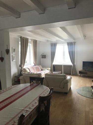 a living room with two beds and a couch at le gîte de la Tourette in Hohrod