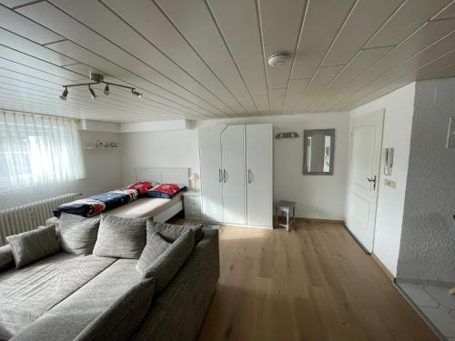 a living room with a couch in the middle of a room at Schöne Ferienwohnung in ruhiger Lage in Tuningen