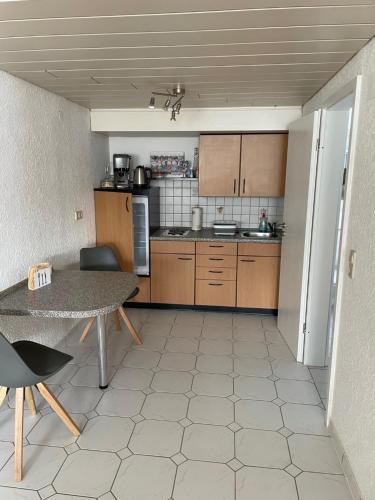 a small kitchen with a table and a table and a table and a tableablish at Schöne Ferienwohnung in ruhiger Lage in Tuningen