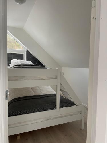 a white bunk bed in a white room at Hytte på Sørlandet - Søgne in Søgne