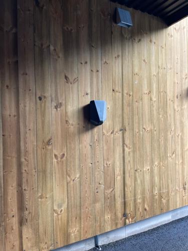 a wooden wall with a blue box on it at Hytte på Sørlandet - Søgne in Søgne