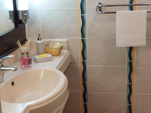 a bathroom with a white sink and a toilet at STUDIO 1015 in Sainte-Anne