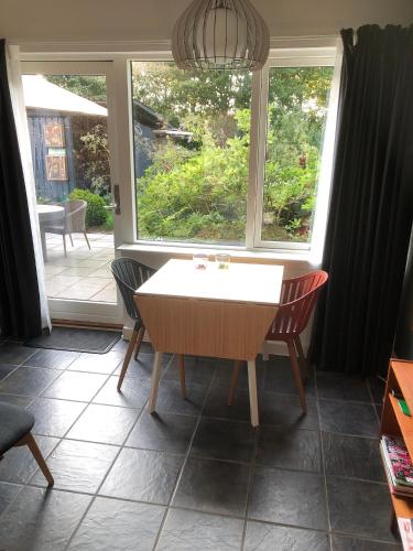 a table and chairs in a room with a window at Fly B&B in Skive